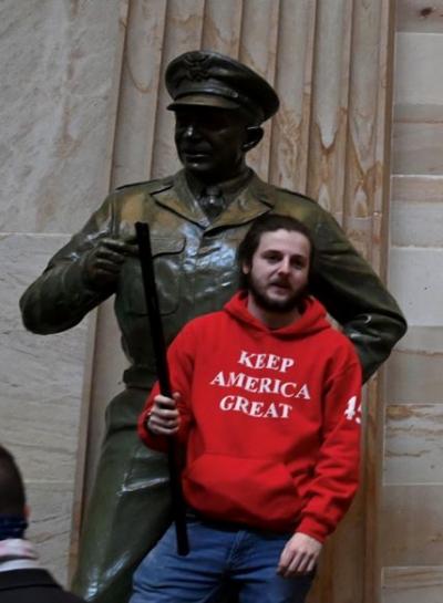 Protester in front of Eisenhower statue in Capitol's Statuary Hall